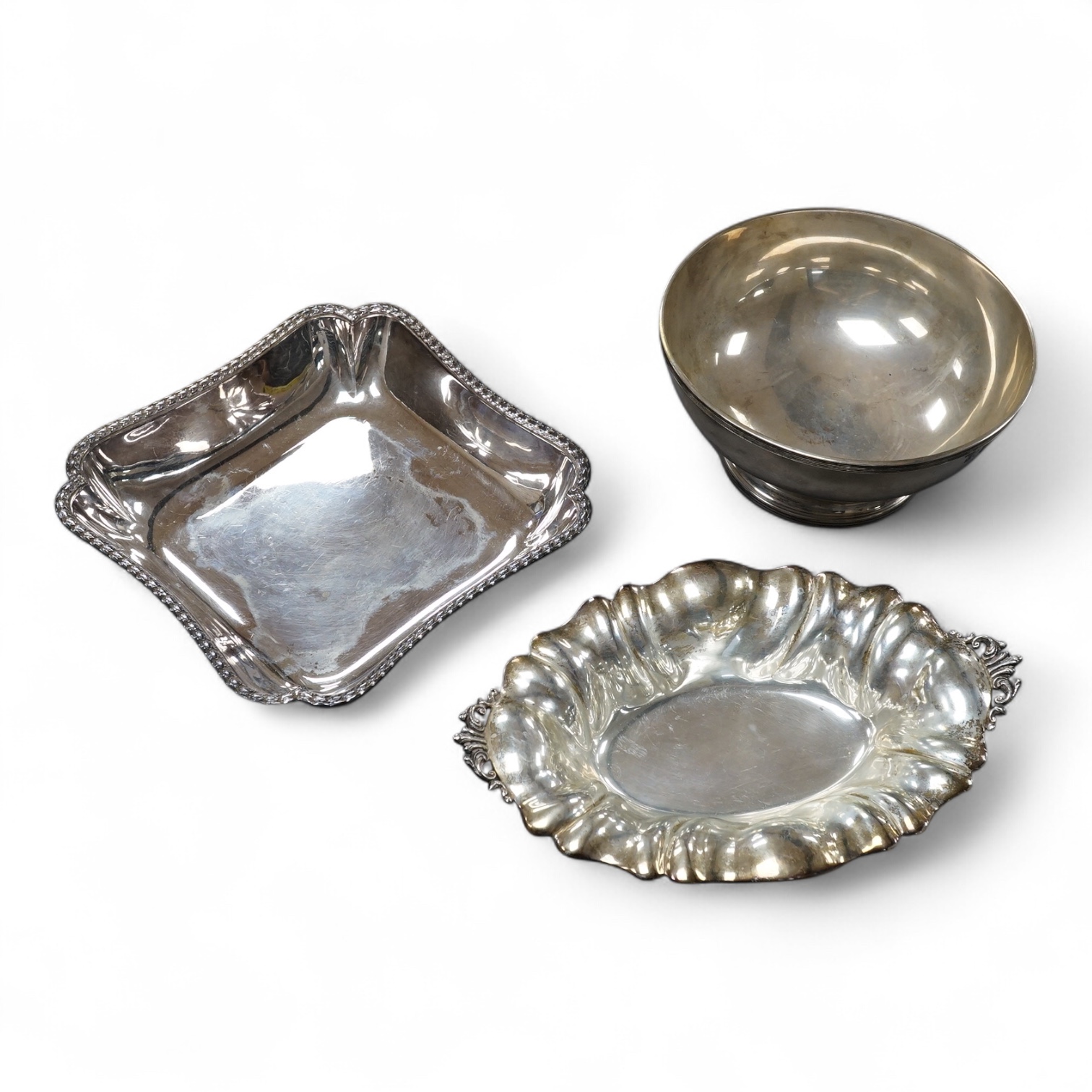 A 20th century Portuguese 833 standard fruit bowl, diameter 20cm, together with an Italian 800 standard two handled dish and a French 950 standard dish, gross 43.2oz.